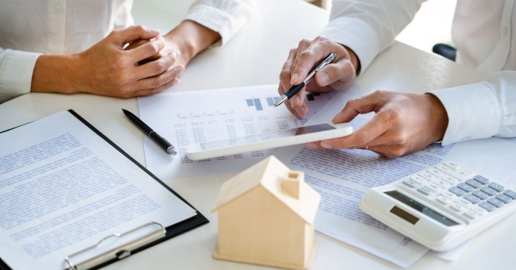 People signing real estate documents