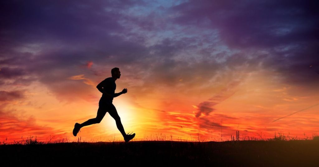 Someone running against the backdrop of a beautiful sky